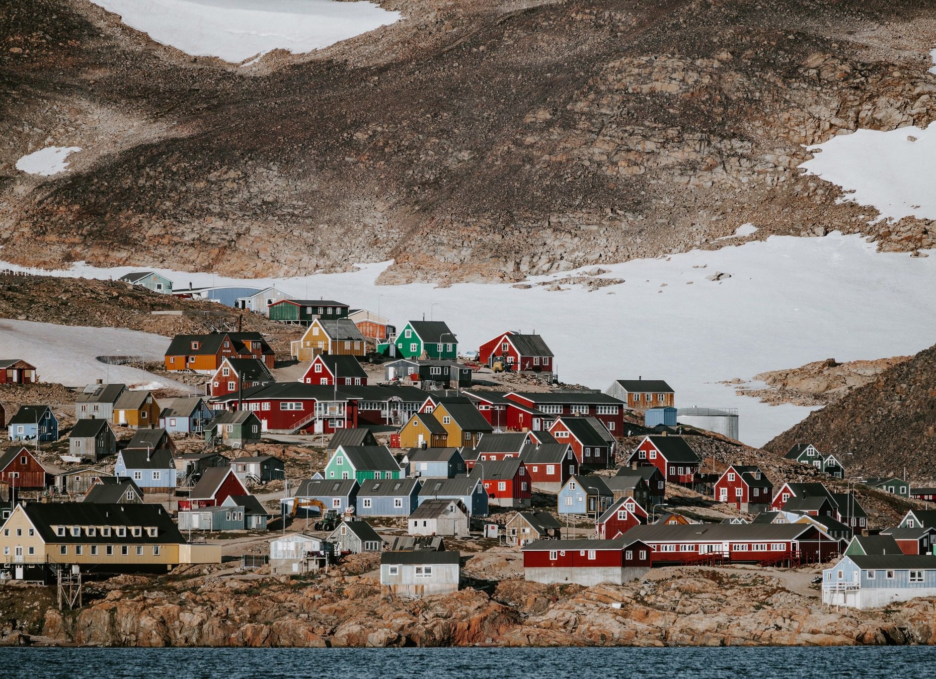 Small Town Surrounded By Snowy Mountains In Greenland