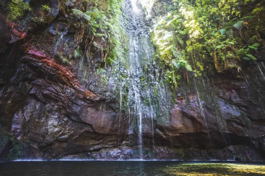 The Fontes Waterfall in Madeira Cascades Over a Rocky Ledge Into a Crystal-Clear Pool Below