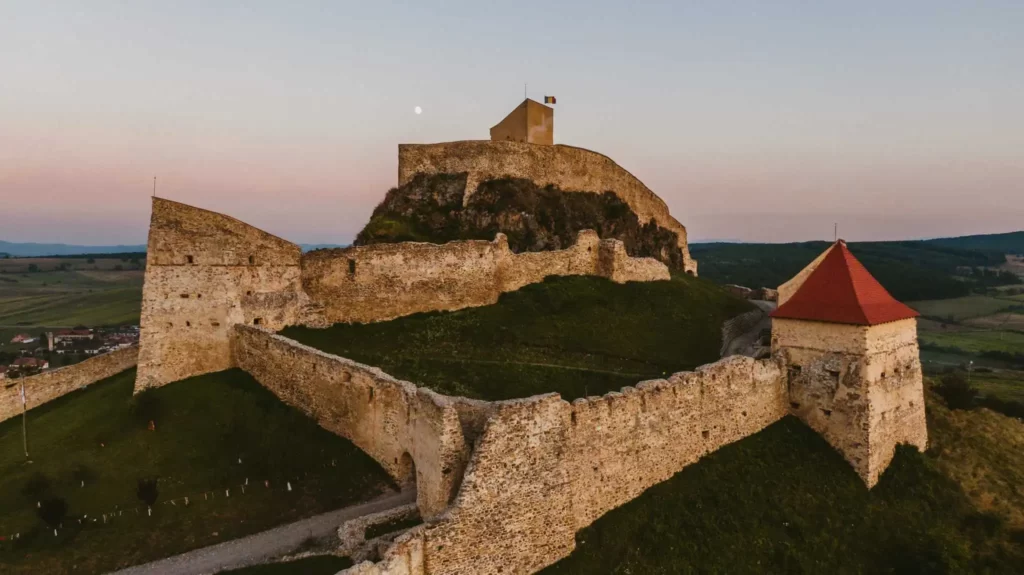 The Imposing Medieval Fortress of Râșnov, Perched Atop a Hill With a Forested Backdrop