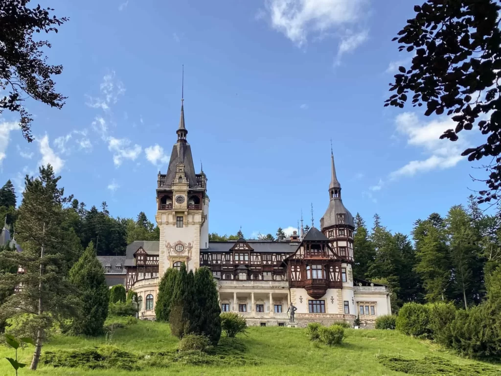 View of the Ornate Neo-Renaissance Peleș Castle Set Amidst the Lush Carpathian Landscape