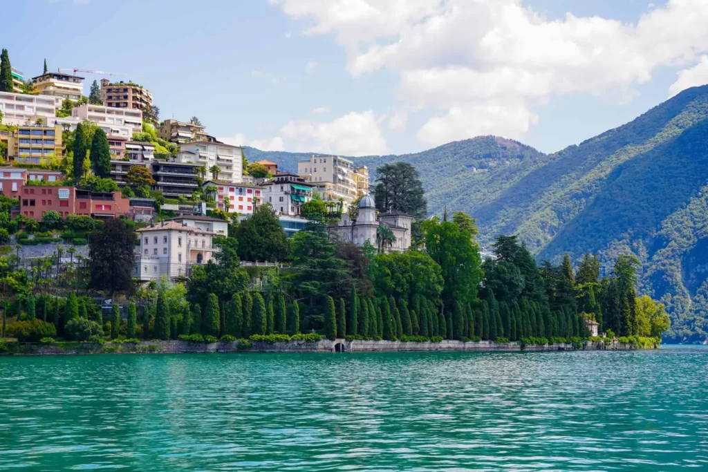 In Lugano, a Must-Do Is Strolling Along the Scenic Waterfront Promenade Lined With Palm Trees, Offering Stunning Lake Views.